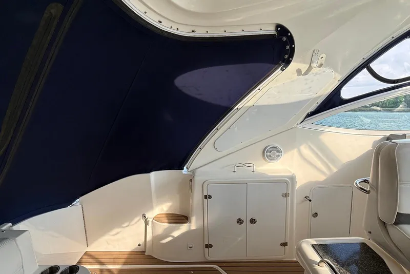 Slide: The Image of 2007 Cruisers Yachts 420 Express interior with seating, table, and kitchenette. - 11