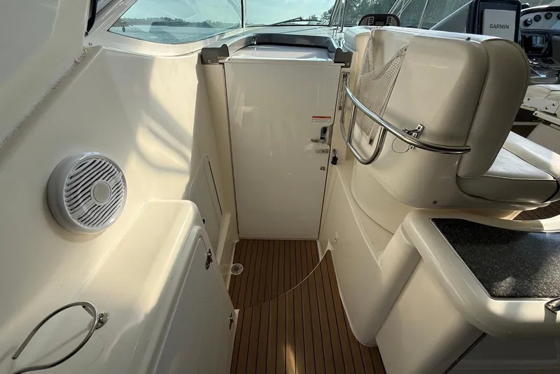 Slide: The Image of 2007 Cruisers Yachts 420 Express interior with helm, kitchenette, and seating area. - 13