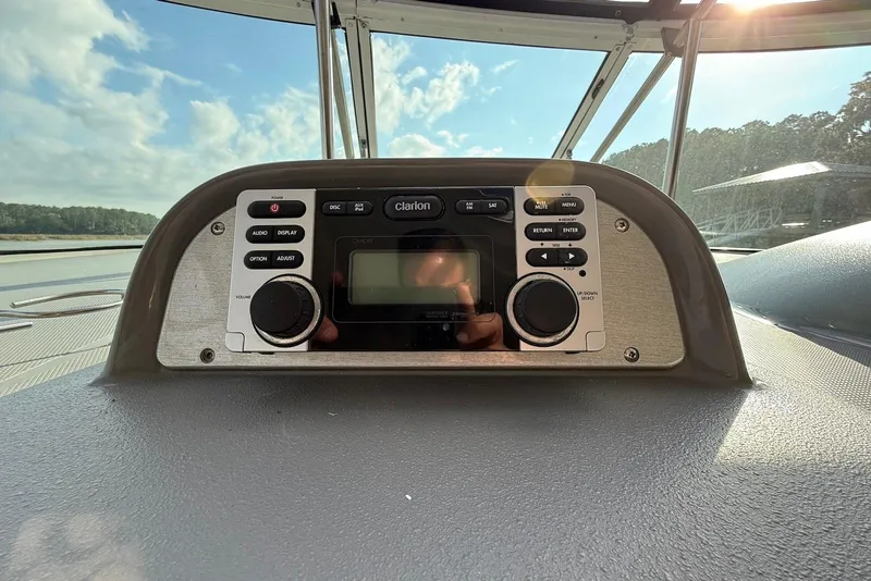 Slide: The Image of 2007 Cruisers Yachts 420 Express interior with blue canopy and white seating. - 14