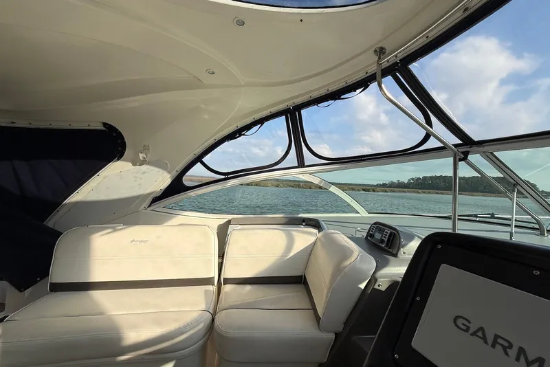 Slide: The Image of 2007 Cruisers Yachts 420 Express interior with white seating and scenic water view. - 15