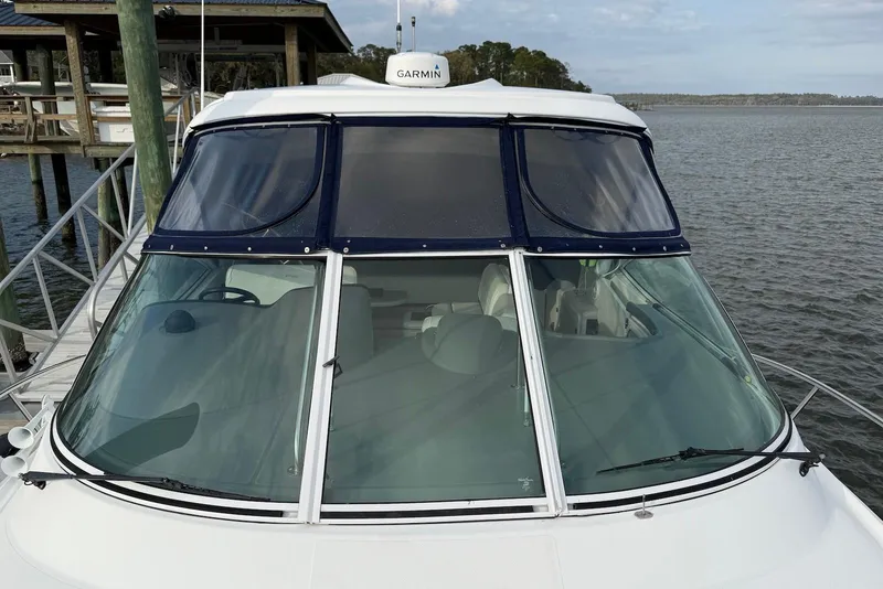 Slide: The Image of 2007 Cruisers Yachts 420 Express on calm water, showcasing sleek design and luxury features. - 2