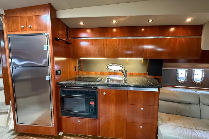 Slide: The Image of Luxurious interior of 2007 Cruisers Yachts 420 Express with leather seating and wooden accents. - 21