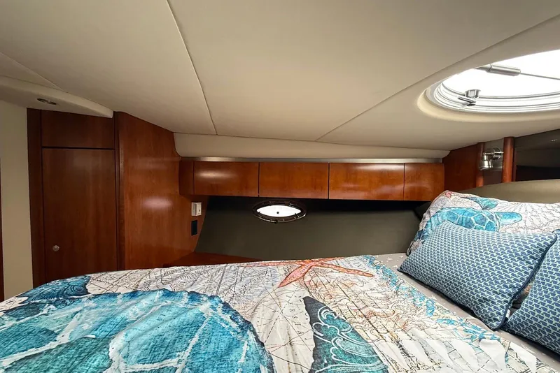 Slide: The Image of Interior of 2007 Cruisers Yachts 420 Express with elegant wood paneling and soft lighting. - 26