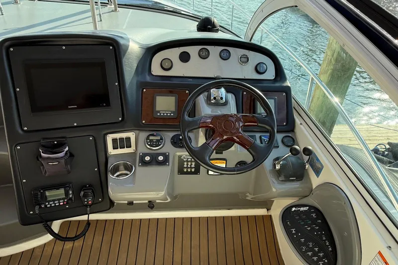 Slide: The Image of 2007 Cruisers Yachts 420 Express with Garmin radar, docked by a scenic waterfront. - 6