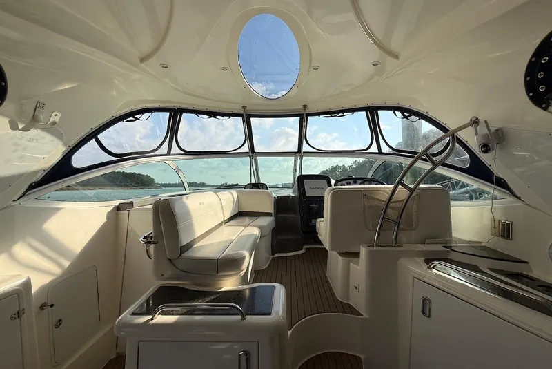 Slide: The Image of 2007 Cruisers Yachts 420 Express bow view with blue cover on deck. - 7