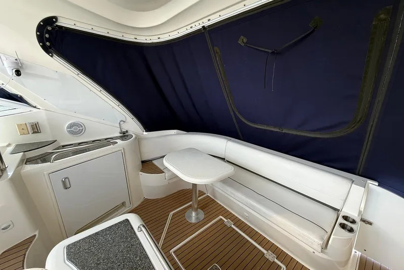 Slide: The Image of 2007 Cruisers Yachts 420 Express helm with Garmin navigation, white seating, and scenic water view. - 8