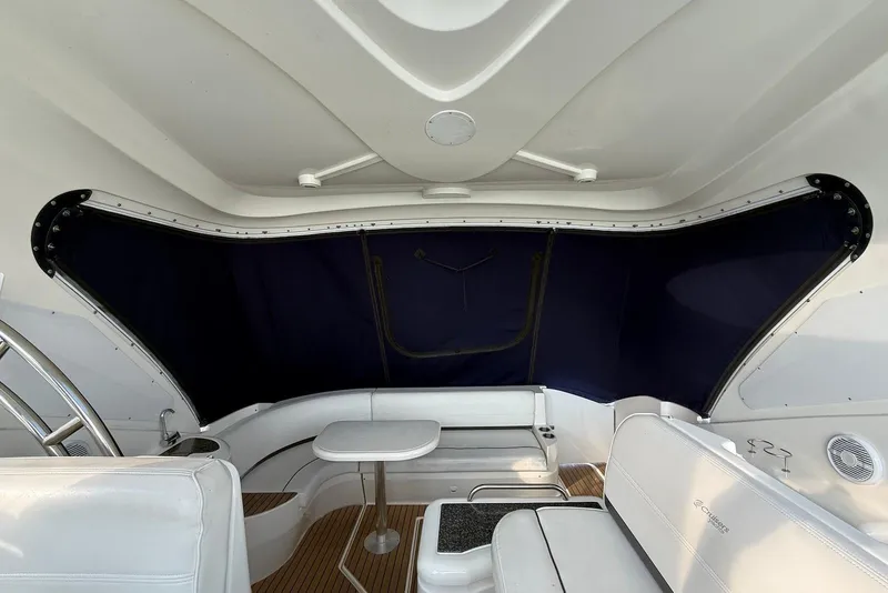 Slide: The Image of 2007 Cruisers Yachts 420 Express helm with steering wheel and navigation controls. - 9