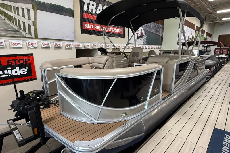 Slide: The Image of 2019 South Bay 523FCR pontoon boat displayed indoors with seating and canopy. - 0