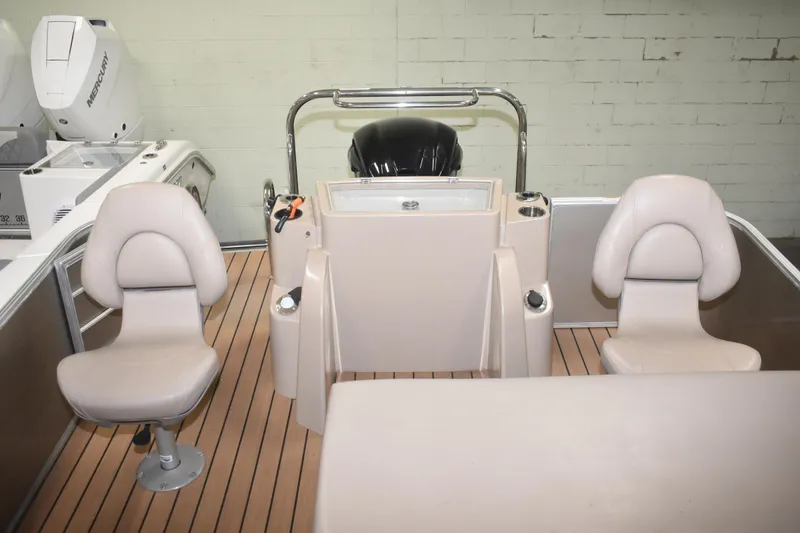 Slide: The Image of 2019 South Bay 523FCR boat interior with beige seating and Mercury engine. - 10