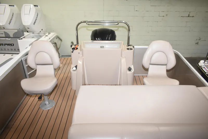 Slide: The Image of 2019 South Bay 523FCR boat interior with beige seating and wood-style flooring. - 14