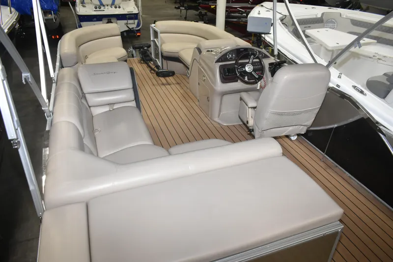 Slide: The Image of 2019 South Bay 523FCR pontoon boat interior with plush seating and modern helm. - 15