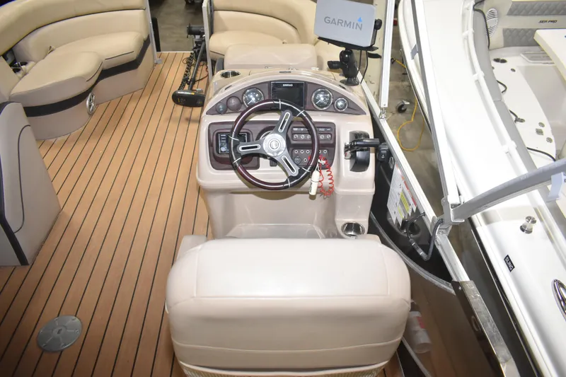 Slide: The Image of 2019 South Bay 523FCR boat interior with steering console and Garmin navigation system. - 17