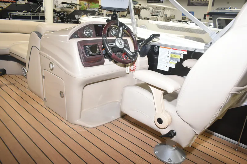 Slide: The Image of 2019 South Bay 523FCR boat interior with steering console and beige seating. - 18