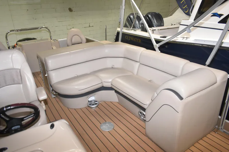 Slide: The Image of 2019 South Bay 523FCR boat interior with beige seating and wood flooring. - 8