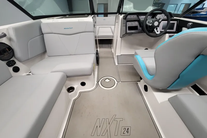 Slide: The Image of 2024 MasterCraft NXT24 boat interior with modern seating and steering console. - 20