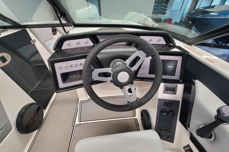 Slide: The Image of 2024 MasterCraft NXT24 boat cockpit with modern steering wheel and control panel. - 21