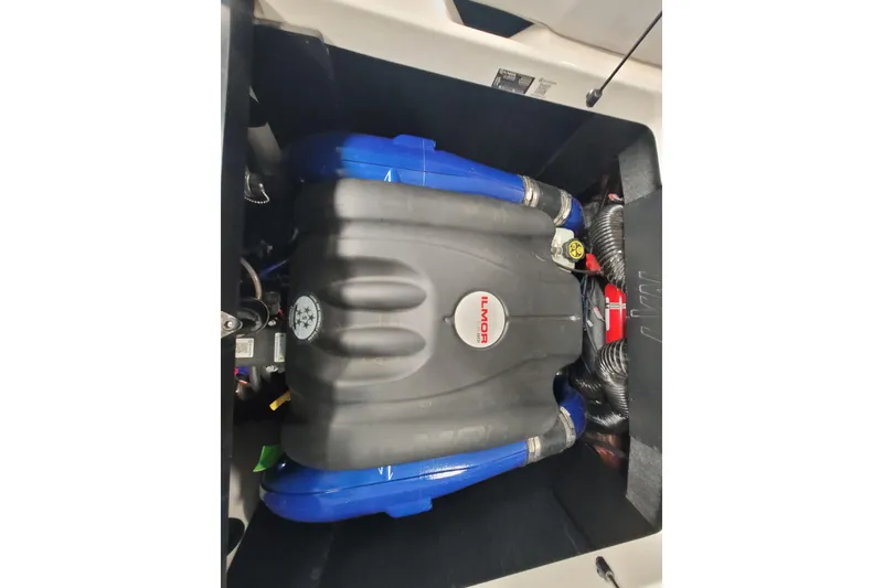 Slide: The Image of 2024 MasterCraft NXT24 engine compartment with Ilmor engine, featuring blue and black components. - 27