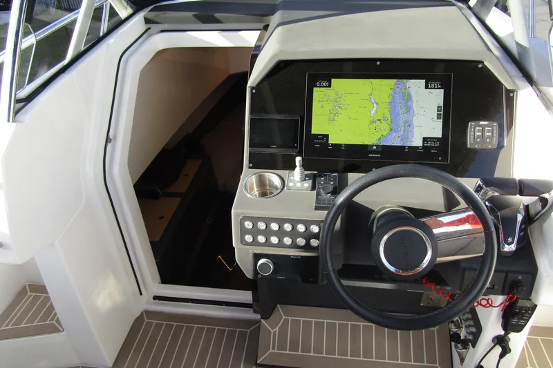 Slide: The Image of 2023 Windy SR28 CC boat cockpit with navigation system and steering wheel. - 11