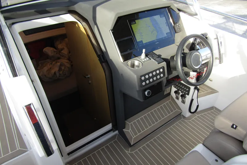 Slide: The Image of 2023 Windy SR28 CC boat cockpit with navigation system and cabin entrance. - 13
