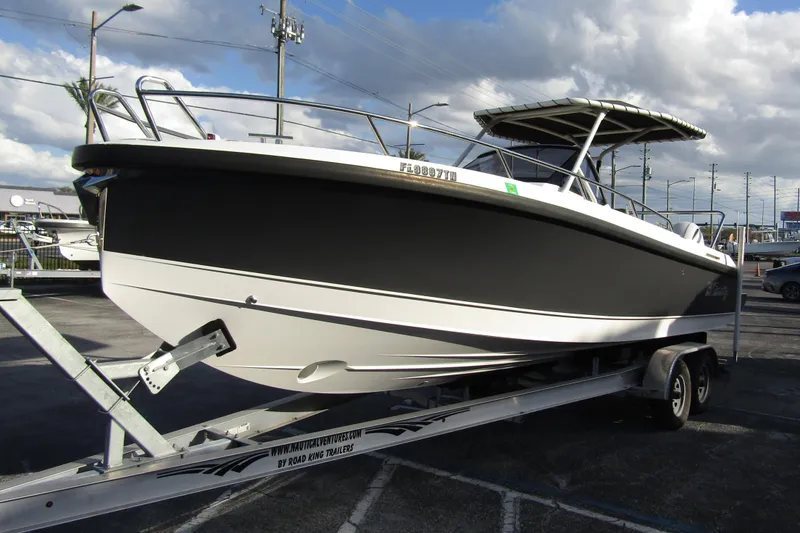 Slide: The Image of 2023 Windy SR28 CC boat on trailer under cloudy sky. - 5