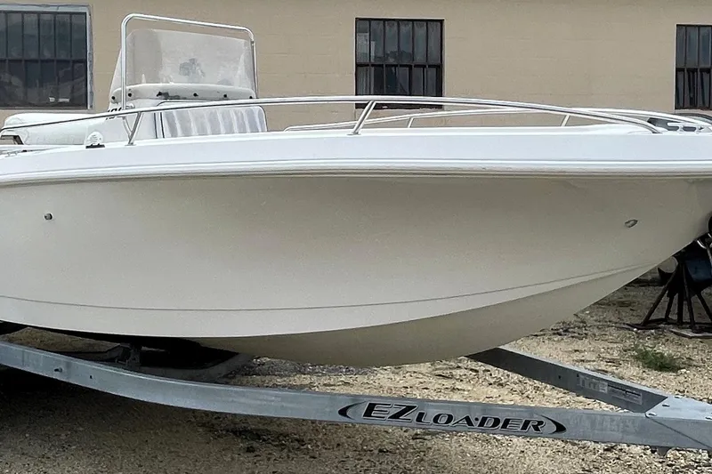 The Image of 1996 PROLINE 19 boat on EZ Loader trailer, parked outdoors. - 0
