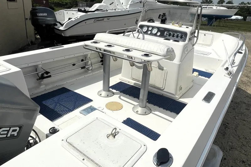 Slide: The Image of 1996 PROLINE 19 boat interior with console, seating, and fishing rod holders. - 2