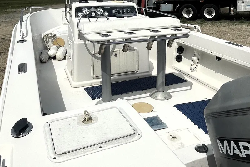 Slide: The Image of 1996 PROLINE 19 boat interior with console, seating, and storage compartments. - 4
