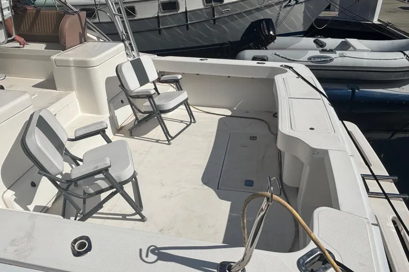 Slide: The Image of 2004 Luhrs 32 Open boat deck with chairs, docked at marina. - 13