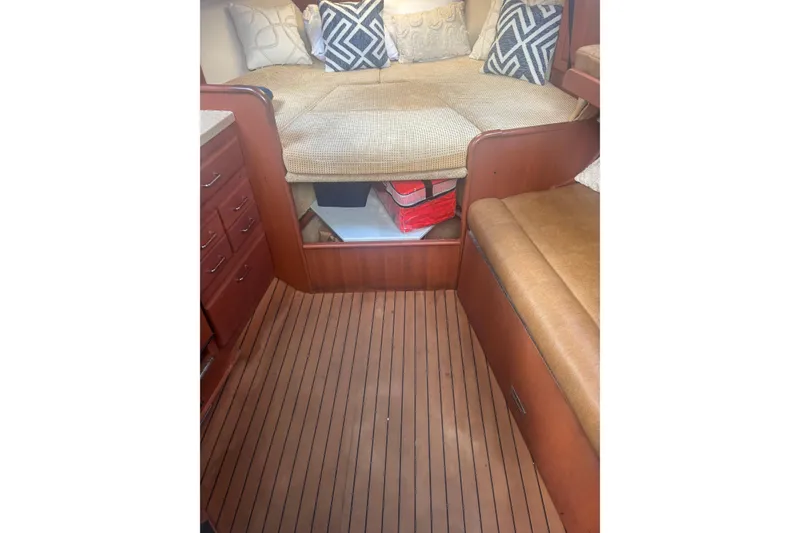 Slide: The Image of 2004 Luhrs 32 Open cabin interior with cushioned seating and wooden flooring. - 22