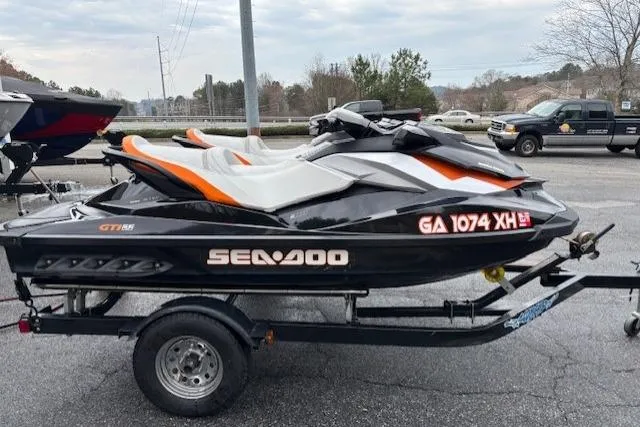 The Image of 2013 Sea-Doo GTI SE 130 jet ski on trailer, parked outdoors. - 0