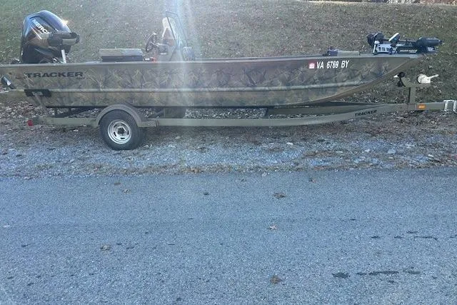 Slide: The Image of 2016 Tracker Grizzly 2072 MVX CC boat on trailer, parked roadside. - 12