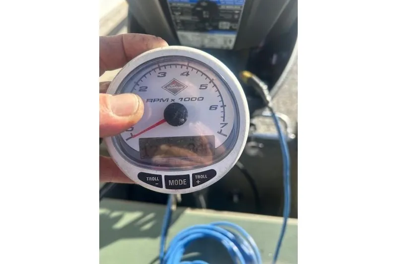 Slide: The Image of Hand holding RPM gauge in 2016 Tracker Grizzly 2072 MVX CC boat cockpit. - 9