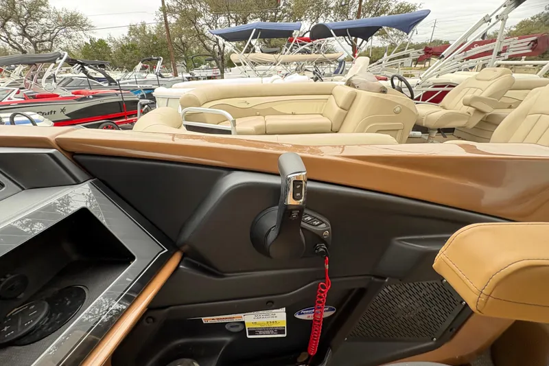 Slide: The Image of 2025 Avalon Excalibur LTD Quad Lounge boat interior with control panel and seating. - 11