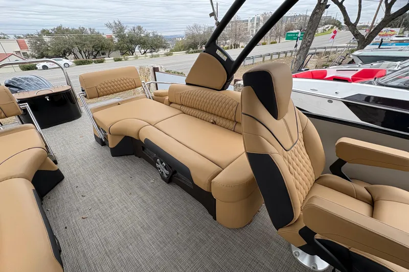 Slide: The Image of 2025 Avalon Excalibur LTD Quad Lounge - 25' with luxurious tan seating and modern design. - 14