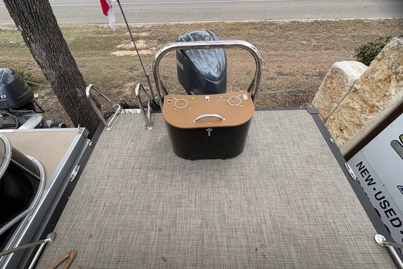 Slide: The Image of 2025 Avalon Excalibur LTD Quad Lounge boat deck with control panel and railing. - 16