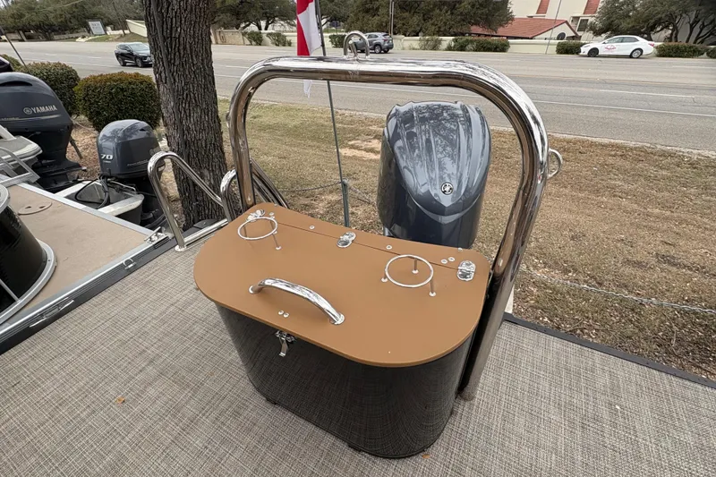 Slide: The Image of 2025 Avalon Excalibur LTD Quad Lounge boat with Yamaha outboard motor, parked on a road. - 17