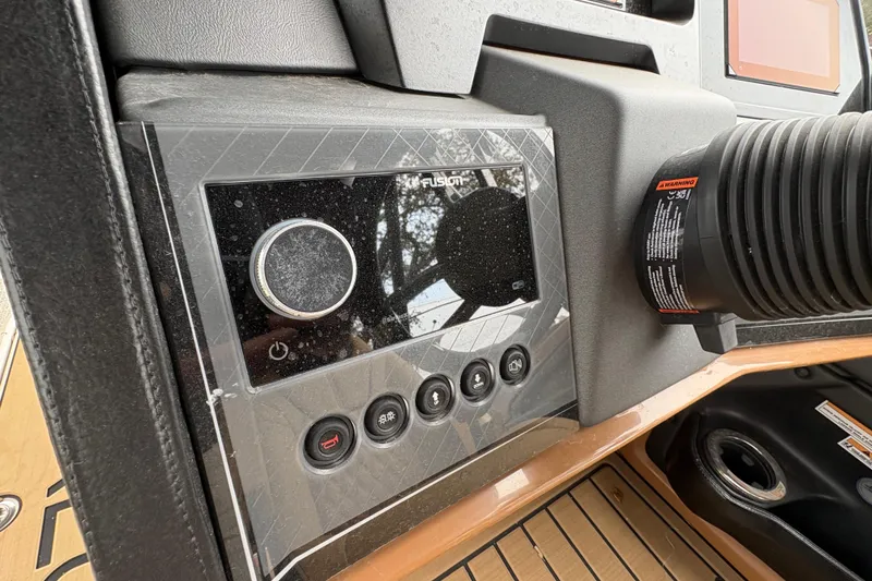 Slide: The Image of Control panel of 2025 Avalon Excalibur LTD Quad Lounge boat, featuring modern audio system. - 9