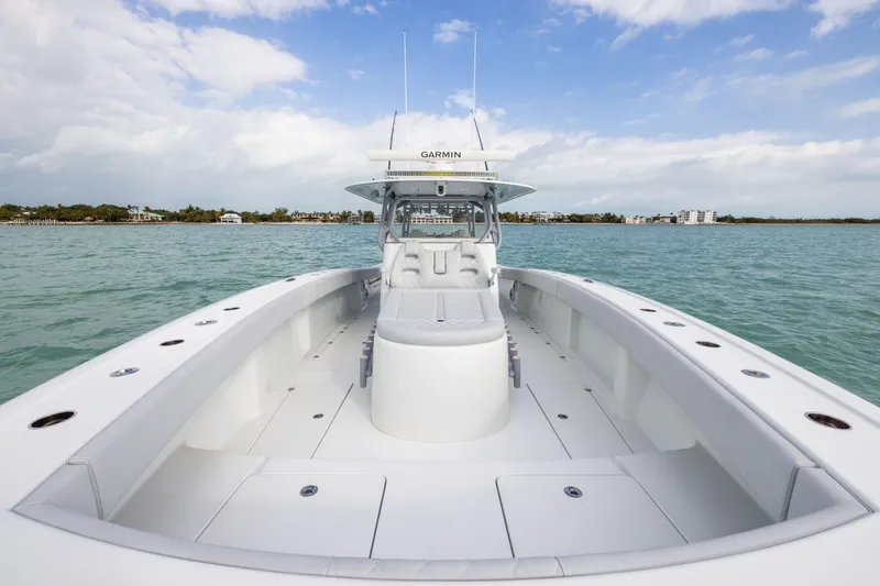 Slide: The Image of 2022 Freeman 42LR boat on calm water, clear sky, luxury seating. - 11