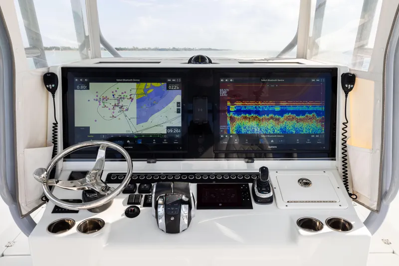 Slide: The Image of Cockpit of 2022 Freeman 42LR boat with dual navigation screens and controls. - 19