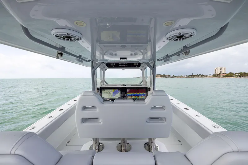 Slide: The Image of Interior view of 2022 Freeman 42LR boat with advanced navigation screens on open water. - 21