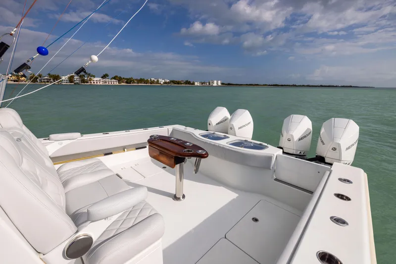 Slide: The Image of Luxury Freeman 42LR boat, 2022 model, with four Mercury engines on calm water. - 29