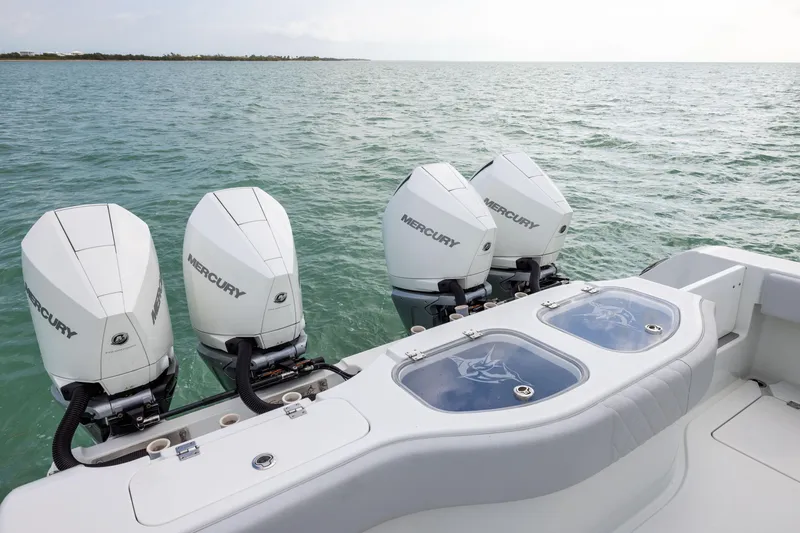 Slide: The Image of Freeman 42LR 2022 boat with four Mercury outboard engines on open water. - 31