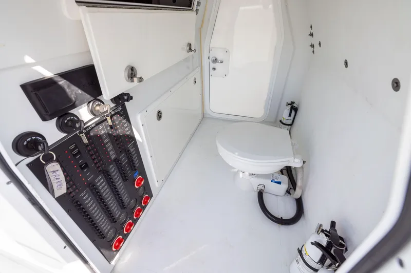Slide: The Image of Interior of a 2022 Freeman 42LR boat featuring a compact bathroom with control panel. - 37