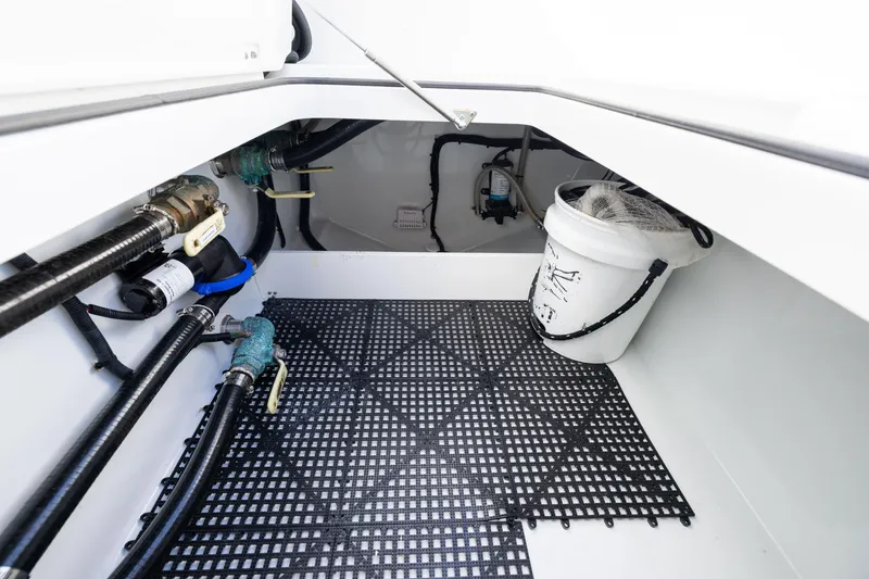 Slide: The Image of Freeman 42LR 2022 boat interior with plumbing and storage bucket. - 38