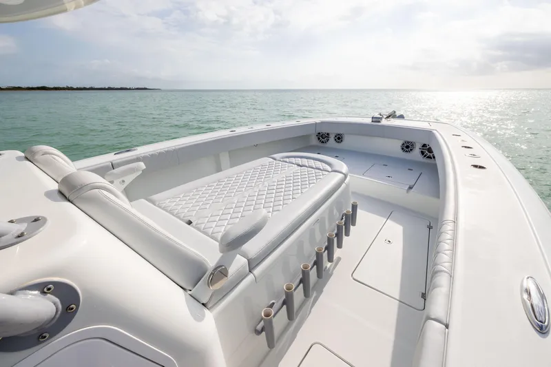 Slide: The Image of 2022 Freeman 42LR boat interior with cushioned seating, rod holders, and ocean view. - 7