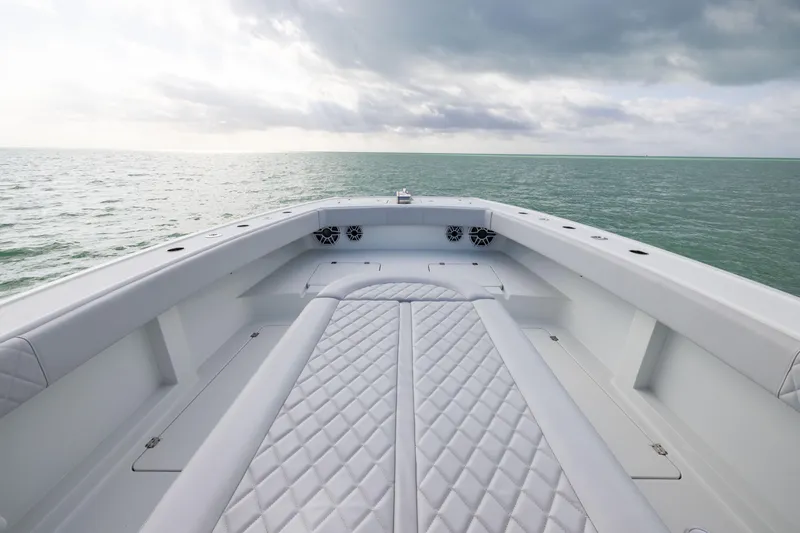 Slide: The Image of 2022 Freeman 42LR boat deck with quilted seating, overlooking calm ocean waters. - 9