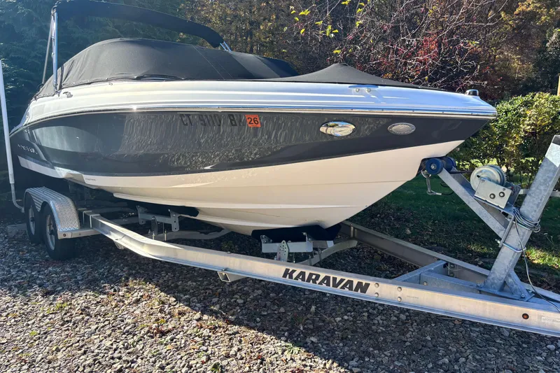 The Image of 2020 Regal 21 OBX boat on Karavan trailer, parked outdoors. - 0
