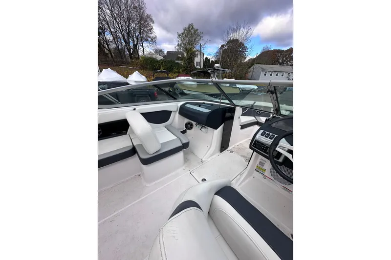Slide: The Image of 2020 Regal 21 OBX boat interior with white seating and modern dashboard. - 10