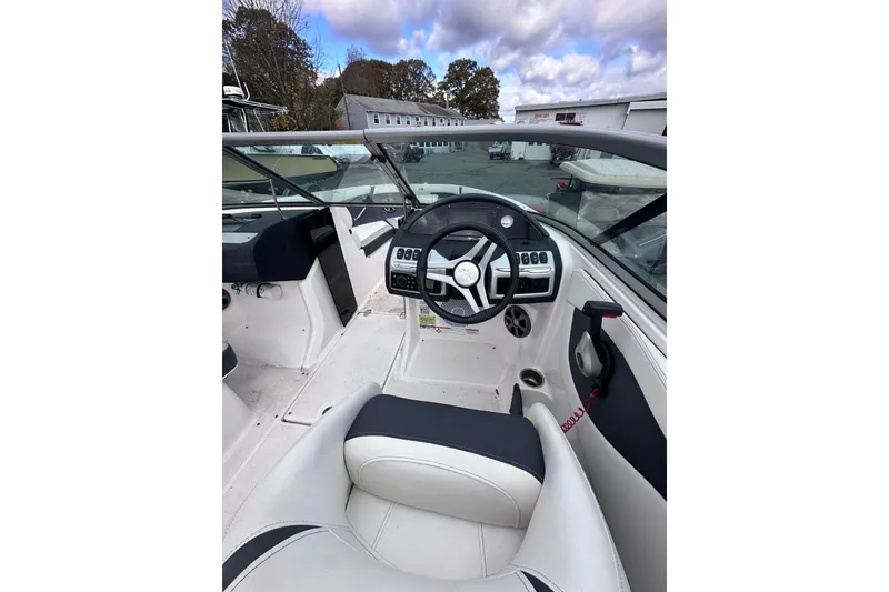 Slide: The Image of 2020 Regal 21 OBX boat interior with steering wheel and dashboard controls. - 11
