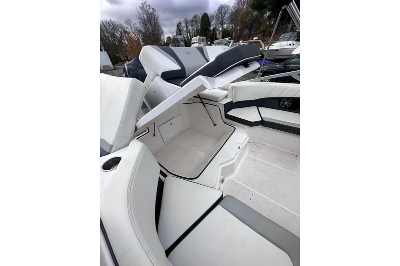 Slide: The Image of 2020 Regal 21 OBX boat interior with white seating and storage compartments. - 9